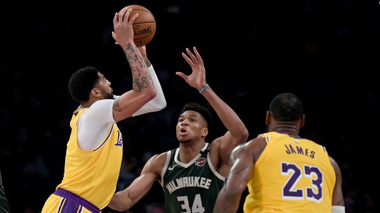 Anthony Davis with LeBron James of the Los Angeles Lakers attempts a shot on Giannis Antetokounmpo of the Milwaukee Bucks