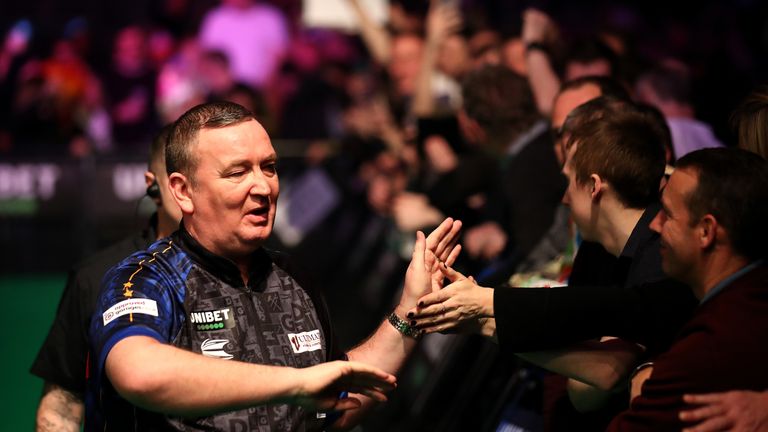 Glen Durrant high fives fans before his match against Fallon Sherrock during day two of the Unibet Premier League at Motorpoint Arena on February 13, 2020 in Nottingham, England.