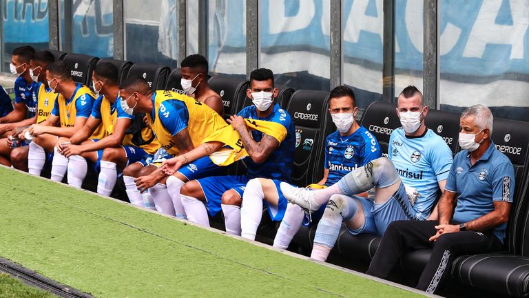 Manager Renato Portaluppi and Gremio substitutes wear face masks on the bench