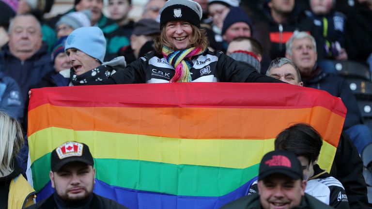 A Hull FC fan holds up a rainbow flag