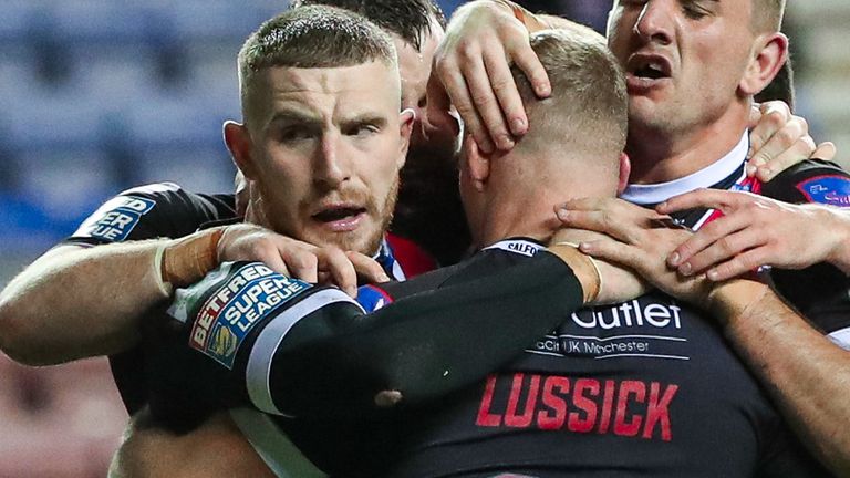 Picture by Alex Whitehead/SWpix.com - 04/10/2019 - Rugby League - Betfred Super League Play-off Semi Final - Wigan Warriors v Salford Red Devils - DW Stadium, Wigan, England - Salford's Joey Lussick celebrates his try with Jackson Hastings and Adam Walker.