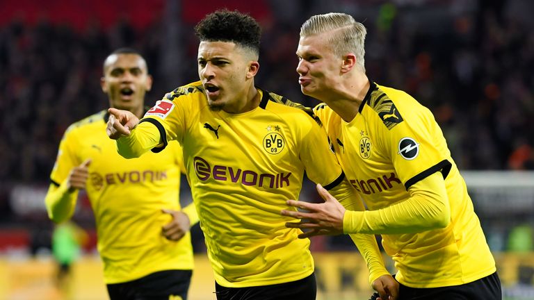 Jadon Sancho celebrates with Erling Haaland