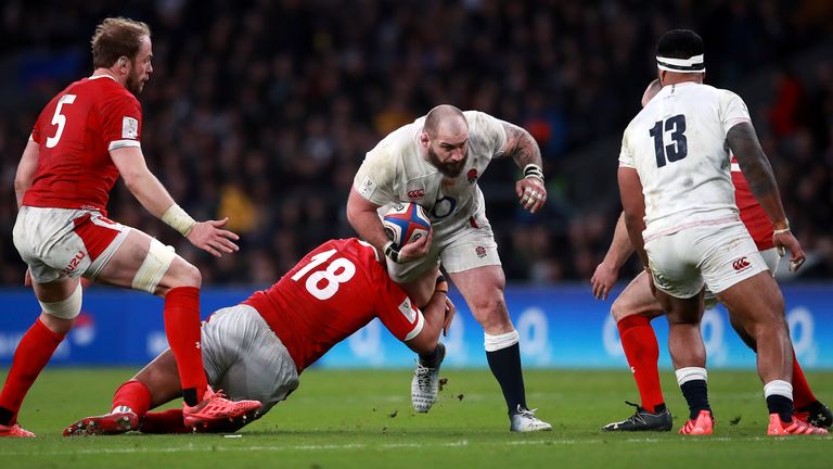 Joe Marler is tackled by Wales' Leon Brown during the match at Twickenham