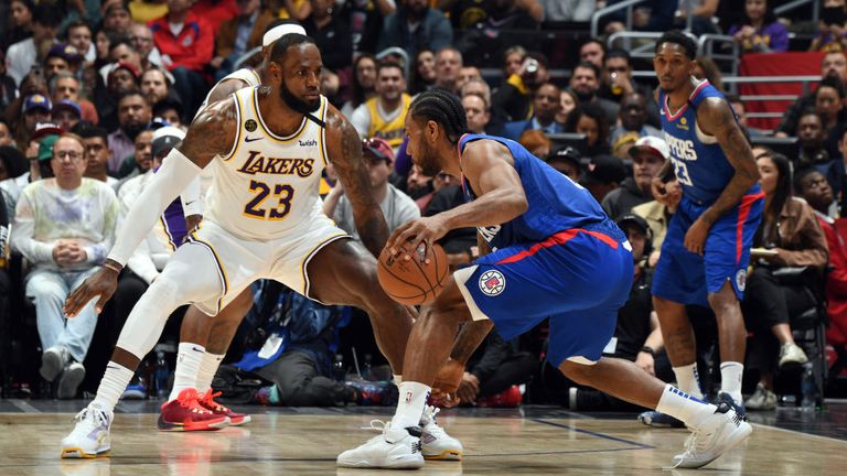 LeBron James of the Los Angeles Lakers plays defense against Kawhi Leonard of the LA Clippers