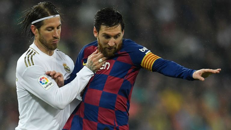 Lionel Messi and Sergio Ramos battle for possession 