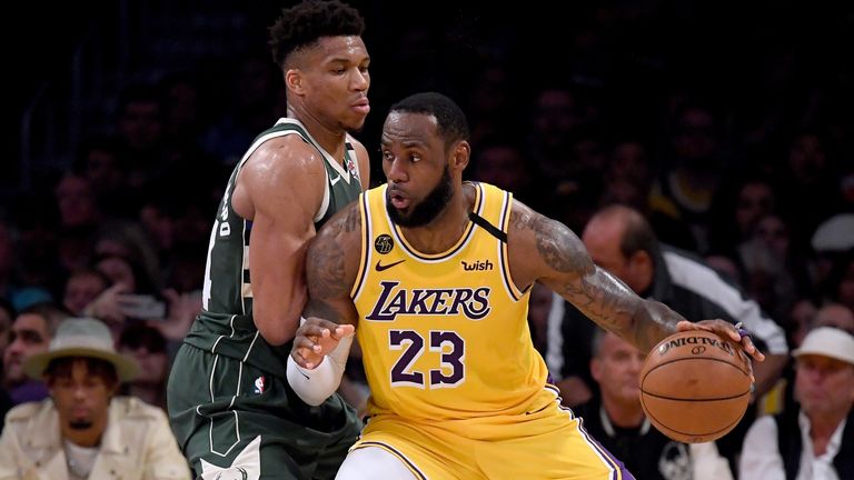LeBron James backs into Giannis Antetokounmpo as the two superstars go head-to-head at Staples Center
