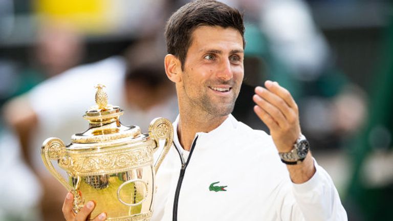 Novak Djokovic of Serbia with the winners trophy after defeating Roger Federer of Switzerland (not pictured) in the Men's Singles Final at The Wimbledon Lawn Tennis Championship at the All England Lawn and Tennis Club at Wimbledon on July 14, 2019 in London, England