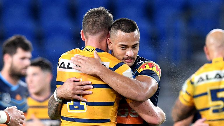 Clint Gutherson of the Eels and Phillip Sami of the Titans embrace after the round 2 NRL match between the Gold Coast Titans and the Parramatta Eels at Cbus Super Stadium on March 22