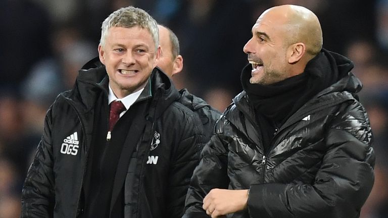 Ole Gunnar Solskjaer speaks to Pep Guardiola during the Premier League match between Man City and Man United at the Etihad Stadium