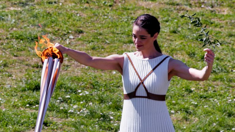 The Olympic flame is lit at a scaled down ceremony