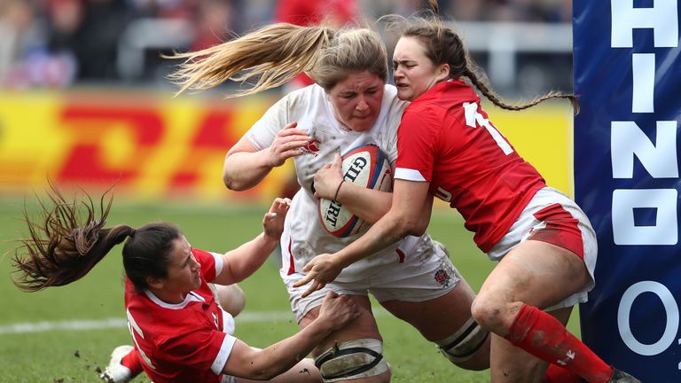 Poppy Cleall of England beats Kayleigh Powell and Lisa Neumann of Wales to score her third try during the Women&#39;s Six Nations match between England and Wales