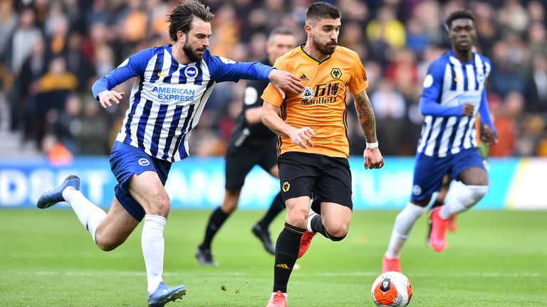 Ruben Neves holds off his marker as Wolves take on Brighton