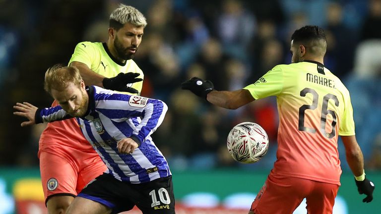 Sergio Aguero of Manchester City, Riyad Mahrez of Manchester City and Barry Bannan of Sheffield Wednesday battle for the ball