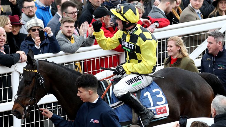 Jockey Nico de Boinville celebrates winning the Sky Bet Supreme Novices' Hurdle on Shishkin