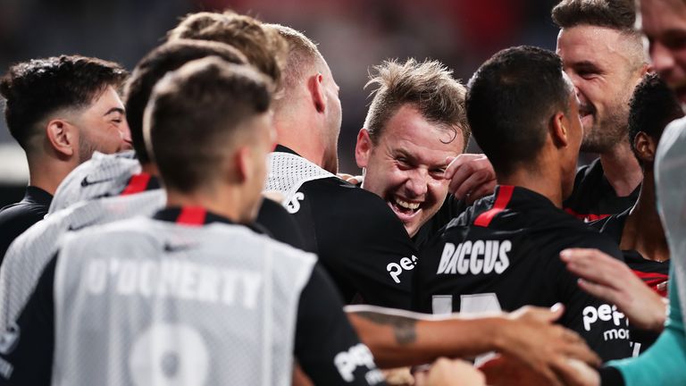 Simon Cox celebrates with team-mates after scoring for Western Sydney Wanderers