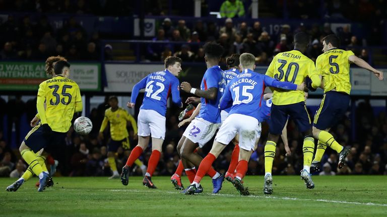 PORTSMOUTH, ENGLAND - MARCH 02: Sokratis Papastathopoulos of Arsenal (R) scores his team's first goal during the FA Cup Fifth Round match between Portsmouth FC and Arsenal FC at Fratton Park on March 02, 2020 in Portsmouth, England. (Photo by Richard Heathcote/Getty Images