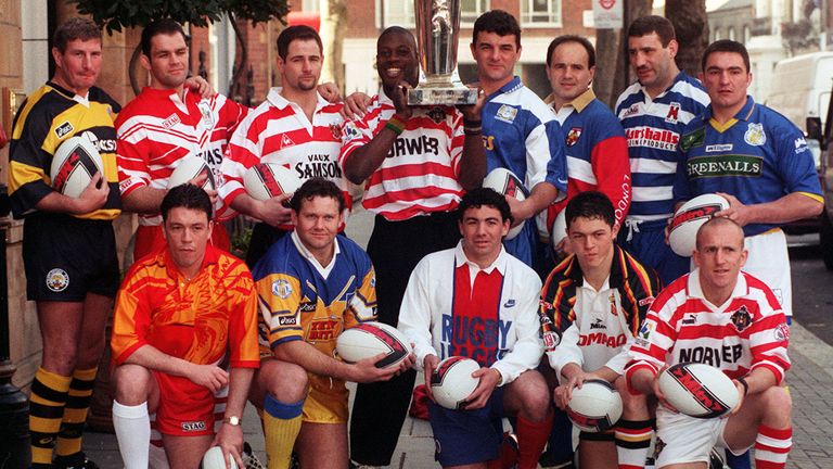 Martin Offiah holds aloft the Sky Sports Stones Super League trophy, at the launch of the league in London. (l/r back) Lee Crooks - Castleford, Dean Busby - St Helens, Paul Topping - Oldham, Martin Offiah - Wigan, Rowland Phillips - Workington, Terry Mattison - London Broncos, Kark Harrison - Halifax and Paul Cullen - Warrington. (l/r front) Mark Aston - Sheffield Eagles, Neil Harmon - Leeds, Patrick Entat - Paris, Robbie Paul - Bradford Bulls and Sean Edwards - Wigan.