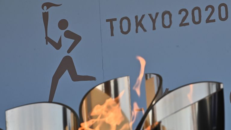 The logo for the Tokyo 2020 torch relay is pictured as the Olympic flame goes on display at the Aquamarine Fukushima aquarium in Iwaki in Fukushima prefecture on March 25, 2020, the day after the historic decision to postpone the 2020 Tokyo Olympic Games. 