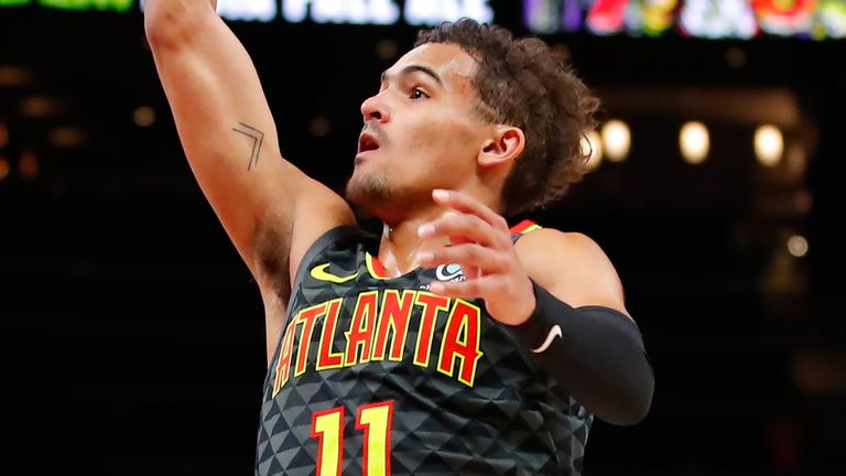 Trae Young lofts a floater against the Charlotte Hornets