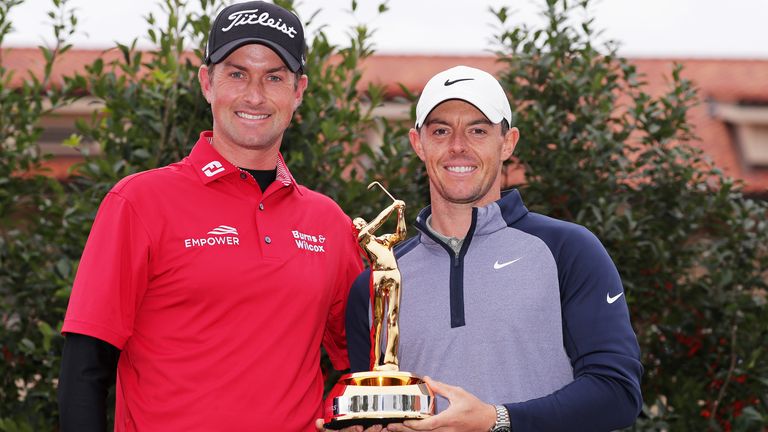 Webb Simpson (L) of the United States poses with Rory McIlroy of Northern Ireland and the winner's trophy after McIlroy won The PLAYERS Championship on The Stadium Course at TPC Sawgrass on March 17, 2019 in Ponte Vedra Beach, Florida.