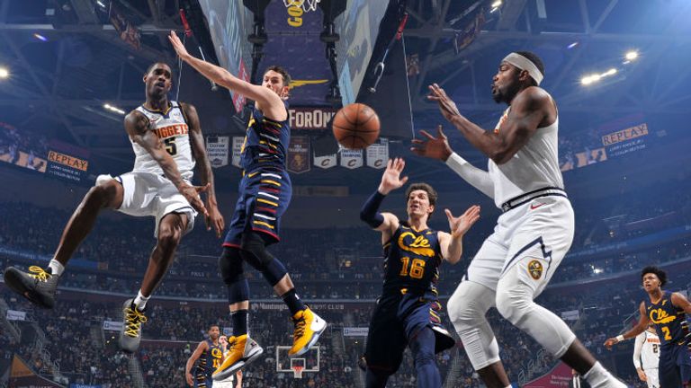 Will Barton of the Denver Nuggets passes the ball to Paul Millsap against the Cleveland Cavaliers