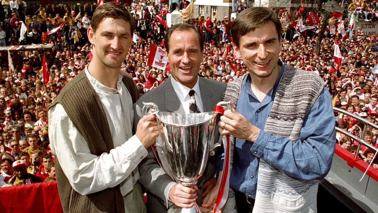 Arsenal manager George Graham celebrates with captain Tony Adams (left) and goal scorer Alan Smith (right), after the team paraded the European Cup Winner's Cup through North London