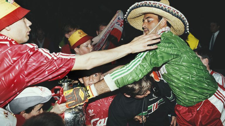 Liverpool goalkeeper Bruce Grobbelaar shares the First Division titles with supporters at Anfield