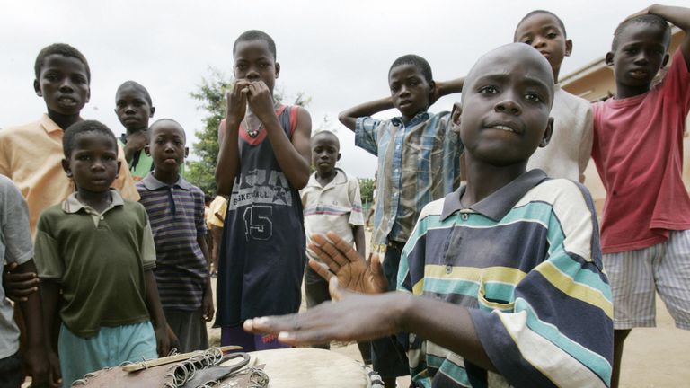 This picture from Buduburam - taken in June 2005, when Alphonso Davies was three years old - shows children celebrating World Refugee Day in the United Nations camp