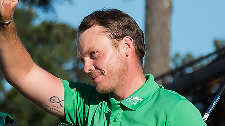 Danny Willett salutes the crowd after holing out on the 18th