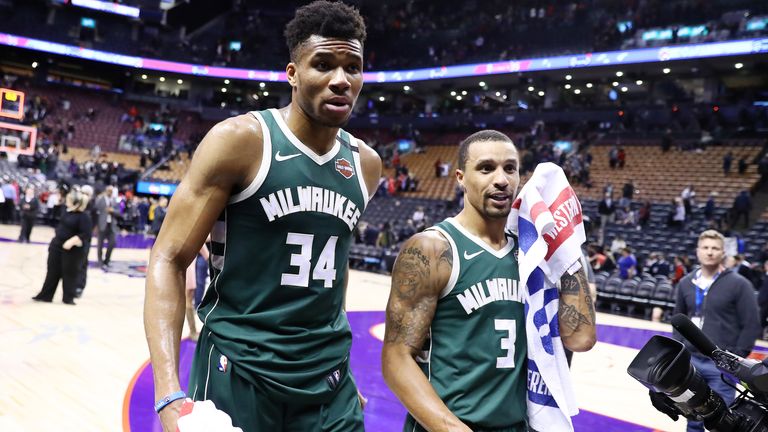 Giannis Antetokounmpo and George Hill leave the court in Toronto