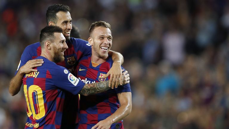Lionel Messi, Sergio Busquets and Arthur celebrate for Barcelona