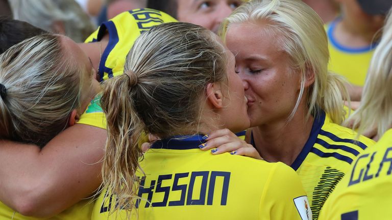 TOPSHOT - Sweden defender Magdalena Eriksson (C) kisses her girlfriend Denmark international Pernille Harder (R) as she celebrates her team's victory at the end of the France 2019 Women's World Cup third-place final football match between England and Sweden, on July 6, 2019, at Nice stadium in Nice south-eastern France. (Photo by Valery HACHE / AFP) (Photo credit should read VALERY HACHE/AFP via Getty Images)