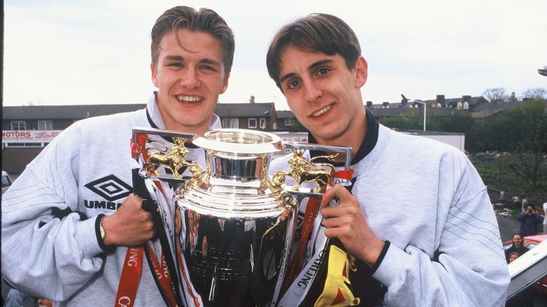 David Beckham and Gary Neville of Manchester United celebrate with the Premiership Trophy during the celebration parade May 12, 1996