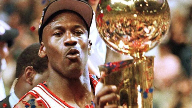 Michael Jordan lifts the Larry O&#39;Brien trophy after leading the Chicago Bulls to victory in the 1998 NBA Finals