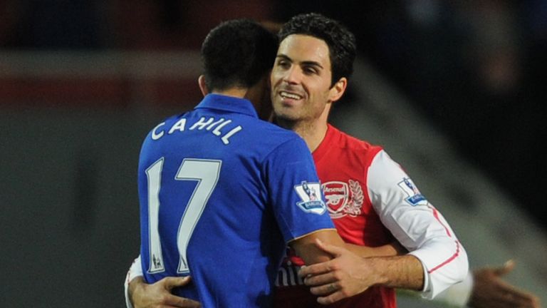 Cahill embraces Arteta during a match in 2011 between Everton and Arsenal