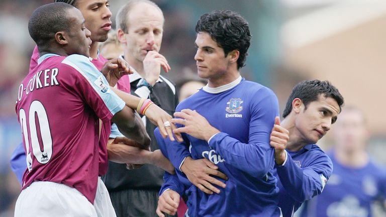 Arteta is dragged away by Cahill during a match with West Ham in 2006