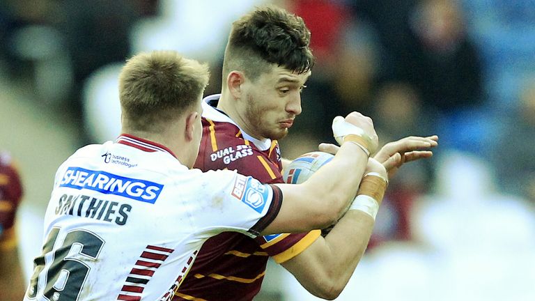 Morgan Smithies tackles Huddersfield's Sam Wood 