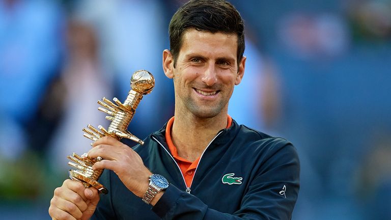Novak Djokovic of Serbia celebrates the victory as he holds the winners trophy following the men's singles final against Stefano Tsitsipas of Greece during day 9 of the Mutua Madrid Open at La Caja Magica on May 12, 2019 in Madrid, Spain.