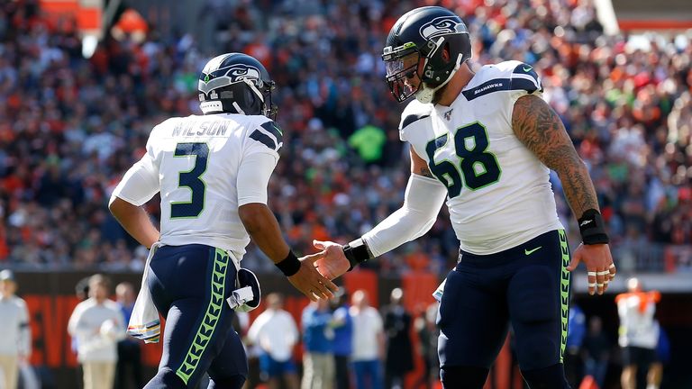 Russell Wilson #3 of the Seattle Seahawks is congratulated by Justin Britt #68 after scoring a touchdown during the game against the Cleveland Browns at FirstEnergy Stadium on October 13, 2019 in Cleveland, Ohio. Seattle defeated Cleveland 32-28.