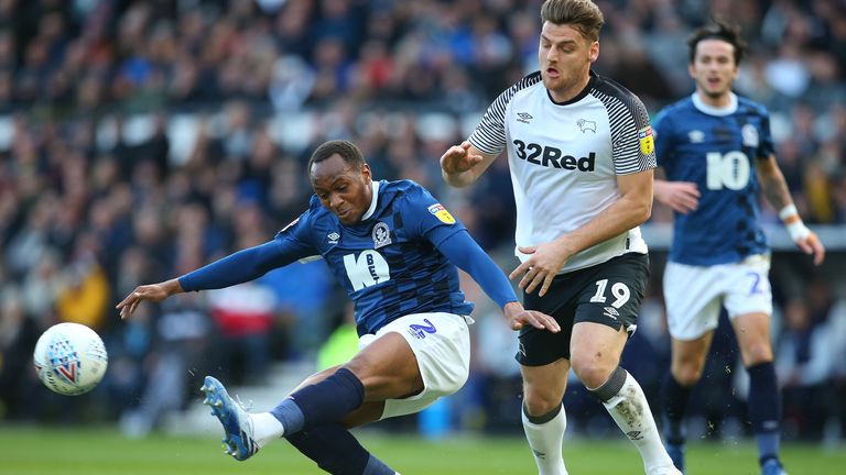 Ryan Nyambe of Blackburn Rovers wins the ball from Derby County's Chris Martin