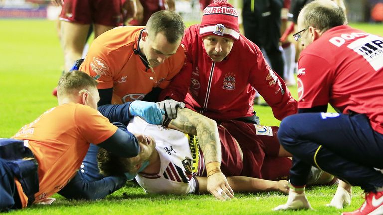 Wigan's Sam Powell receives medical assistance