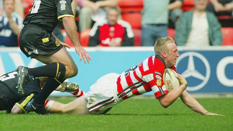 WIGAN - APRIL 18: Shaun Briscoe of Wigan dives to score during the Tetley's Super League game between Wigan Warriors and St Helens on April 18, 2003 at The JJB Stadium, Wigan, England. (Photo by Laurence Griffiths/Getty Images)