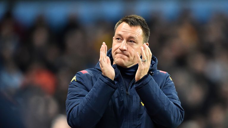 Aston Villa assistant head coach John Terry applauds fans at Villa Park