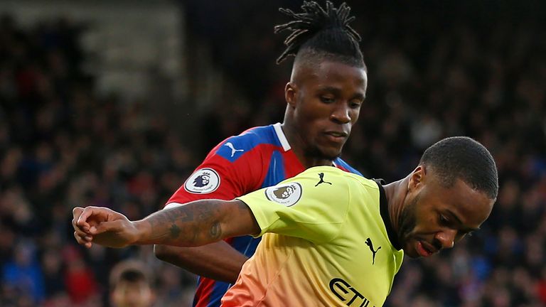 Wilfried Zaha and Raheem Sterling in action 