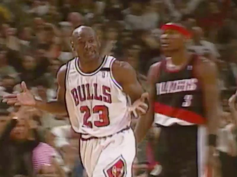 Michael Jordan of the Chicago Bulls shoots against Dennis Johnson