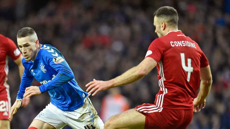 Aberdeen's Andrew Considine tackles Rangers' Ryan Kent (left) during a Scottish Premiership match against Rangers at Ibrox 