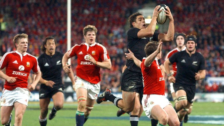 Dan Carter is tackled by Shane Williams 