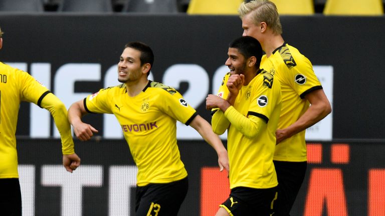 Guerreiro celebrates with team-mates after scoring Dortmund's second just before half-time