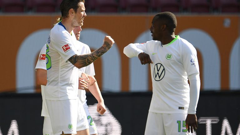 Wolfsburg's German forward Daniel Ginczek (L) celebrates with teammates