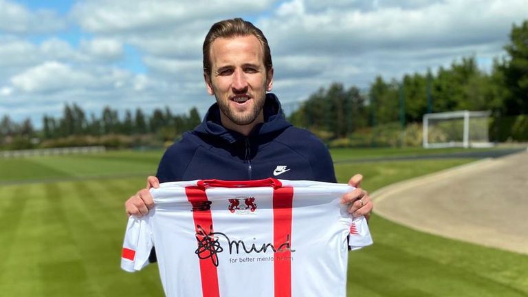 Harry Kane holding the new Leyton Orient shirt, which he has sponsored with charities